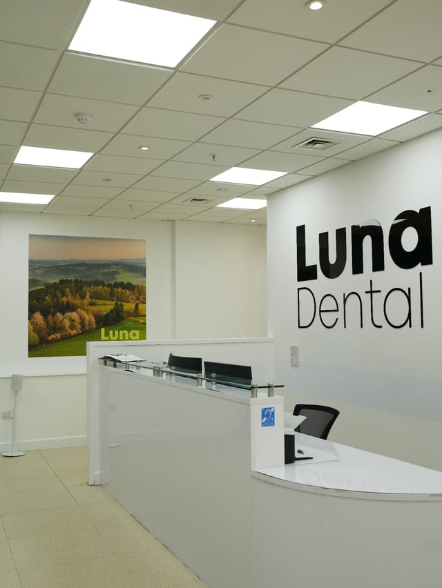 The glass reception desk at Luna Dental, Cardiff city centre