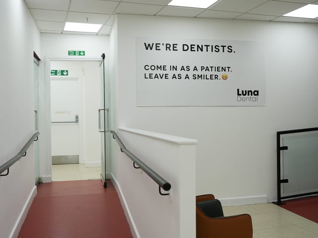 Luna Dental wall sign reading Come in as a patient, leave as a smiler